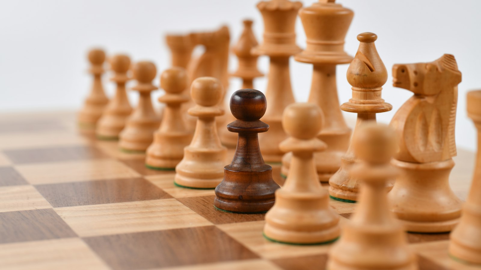 Wooden chess pieces on a chessboard